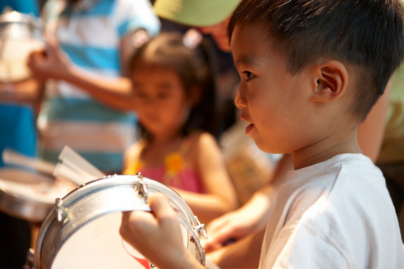 small kid playing on percussion