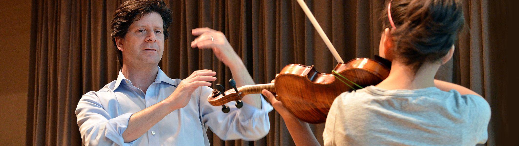 teacher and student playing violin