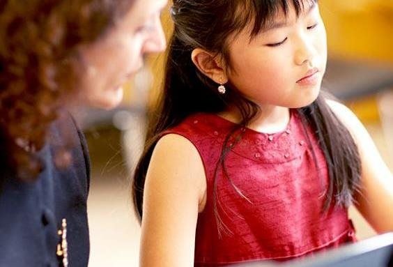 child taking music lessons
